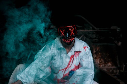 Man Wearing A Black Mask And Bloody Shirt