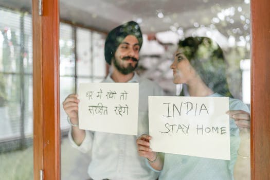 Optimistic young Indian couple staying at home during quarantine