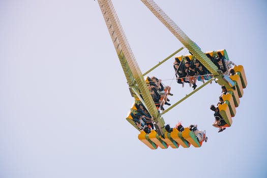 Photo of People Riding a Green and Yellow Amusement Ride