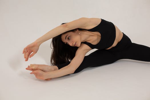 Flexible woman doing stretching exercise during workout