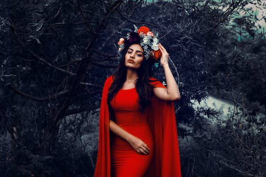 Young Brunette in a Red Dress and a Flower Crown Posing Outdoors
