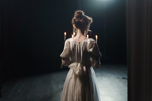 Back View Of A Woman Holding A Candelabrum