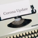 A Vintage Typewriter With Corona Update Typed On White Paper
